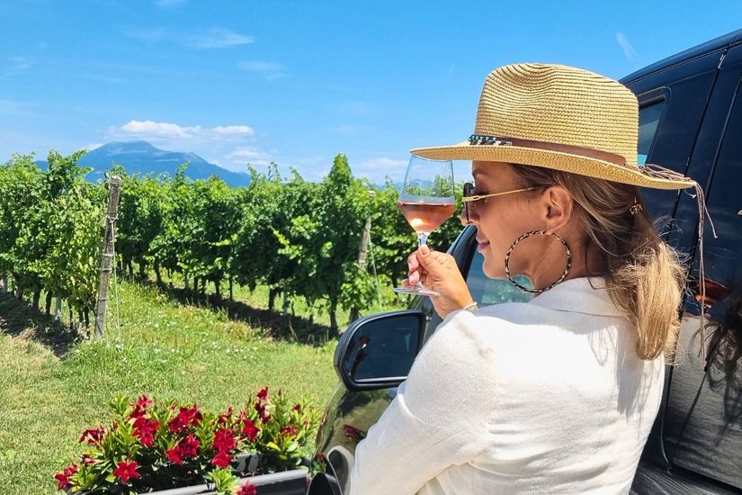 glass of Lugana white wine with vineyards in the background
