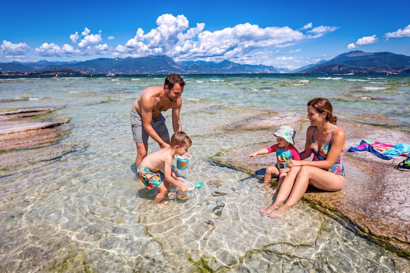 Family with young children on Jamaica beach in Sirmione